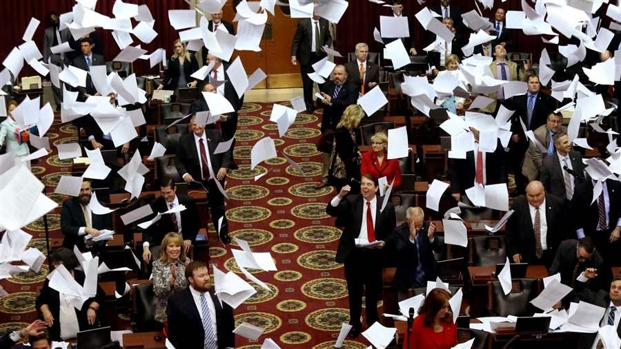 Legislative assembly room with documents flying representing policy development and legislative review
